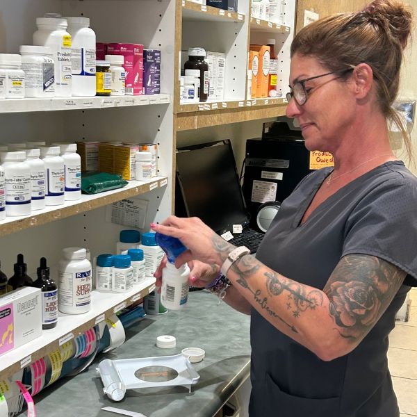 A vet filling medicine into a bottle